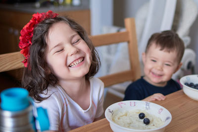 Siblings fooling around at the breakfast table