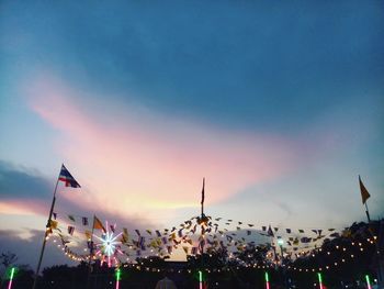 Low angle view of illuminated buildings against sky during sunset