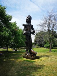 Statue in park against sky