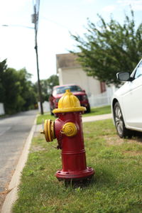 Fire hydrant by road against sky