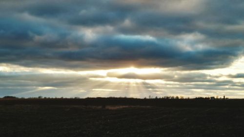 Scenic view of landscape against cloudy sky