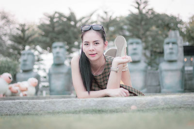 Portrait of smiling young woman holding plant