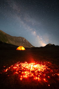 Night landscape long exposure. burning coals are the remains of a fire against the backdrop of a