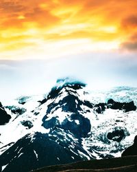 Scenic view of snowcapped mountains against sky during sunset