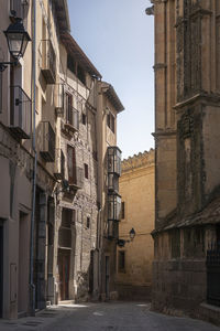 Street amidst buildings against sky in city