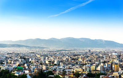 High angle view of houses and mountains against clear sky