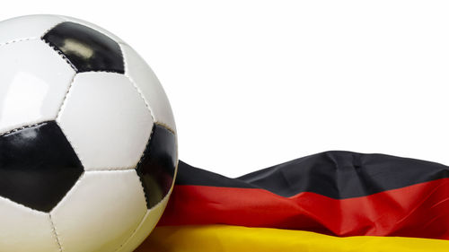 Close-up of soccer ball over white background