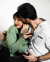 Side view of young woman using phone