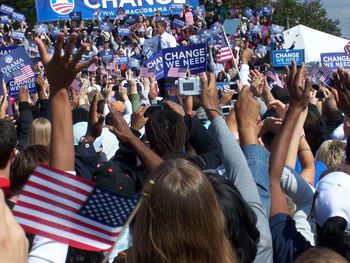 Crowd of people cheering at obama political rally for his 2008 presidential run. 