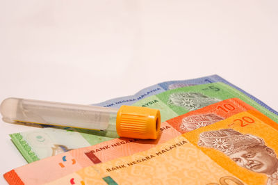 Close-up of colored pencils over white background