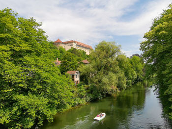 Scenic view of lake by trees against sky