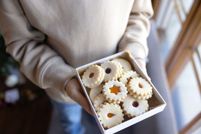 Midsection of woman holding gift