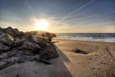 Scenic view of beach against sky during sunset