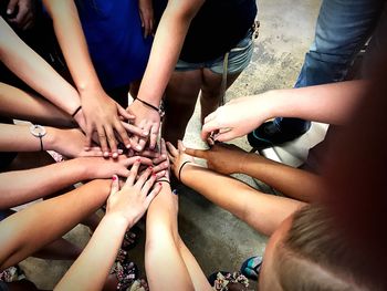Low section of friends standing on hand