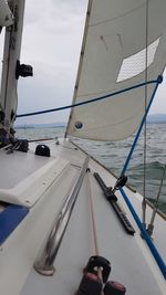 Sailboat sailing in sea against sky