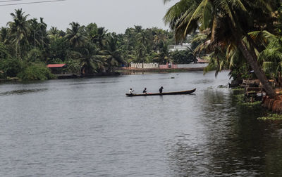 Scenic view of people in lake