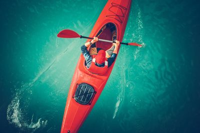 High angle view of mid adult man kayaking on sea