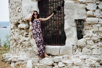 Woman on brick wall