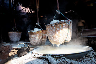 Clothes hanging in wicker basket for sale at market stall