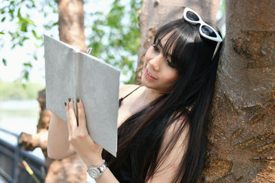 Portrait of beautiful woman holding camera