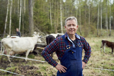 Portrait of confident farmer standing on field