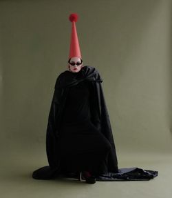 Rear view of woman standing against wall