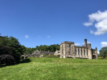 View of building on field against blue sky