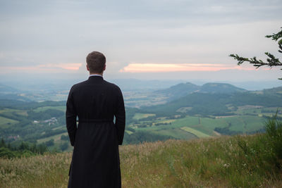 Rear view of priest outdoors