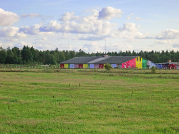 Houses on field against sky