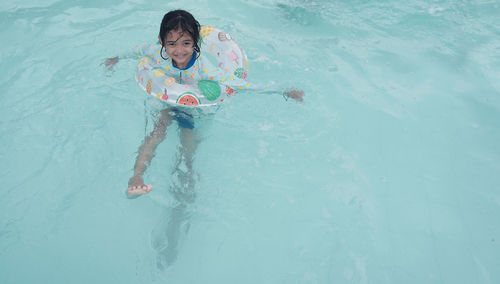 High angle view of boy swimming in sea