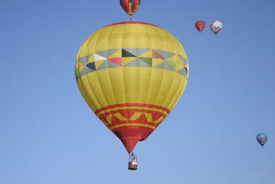 Low angle view of hot air balloon against blue sky