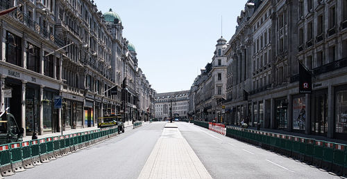 View of city street and buildings against sky