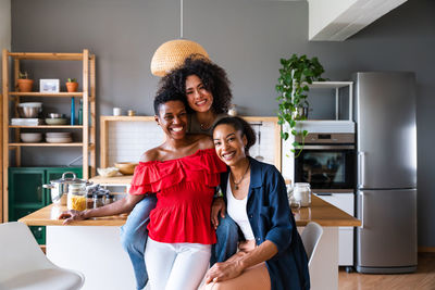 Portrait of young woman standing at home