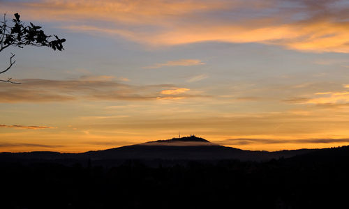 Scenic view of silhouette mountains against sky at sunset