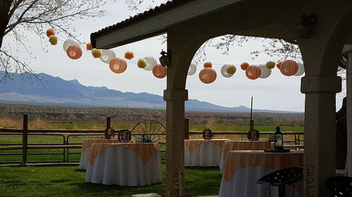 Lanterns hanging on field by mountains against sky