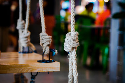 Close-up of swing hanging on rope