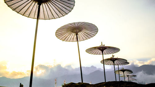 Low angle view of traditional windmill against sky