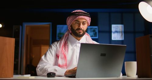 Young man using laptop at office