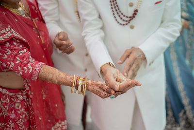Midsection of bride holding hands