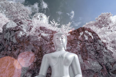 Statue of buddha on rock