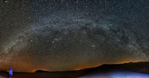 Scenic view of illuminated mountain against sky at night