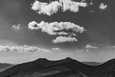 Scenic view of mountains against cloudy sky