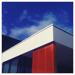 Low angle view of buildings against blue sky