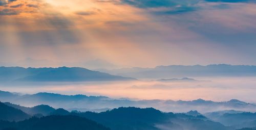 Scenic view of silhouette mountains against sky during sunset