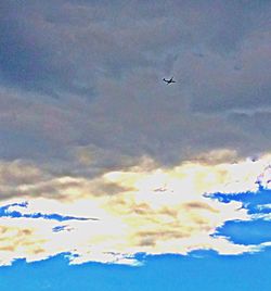 Airplane flying over cloudy sky