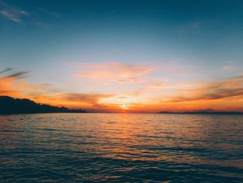Scenic view of sea against romantic sky at sunset