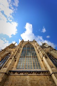 Low angle view of building against cloudy sky