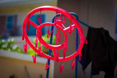 Close-up of red bell hanging on wall