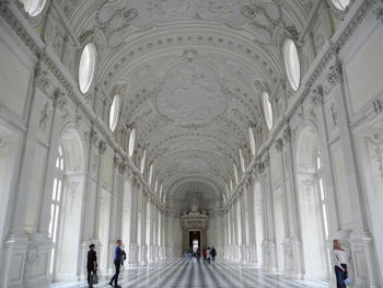 People walking in corridor of building