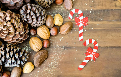 'christmas festive styled pine cones, nut mix and golden glitters background. 